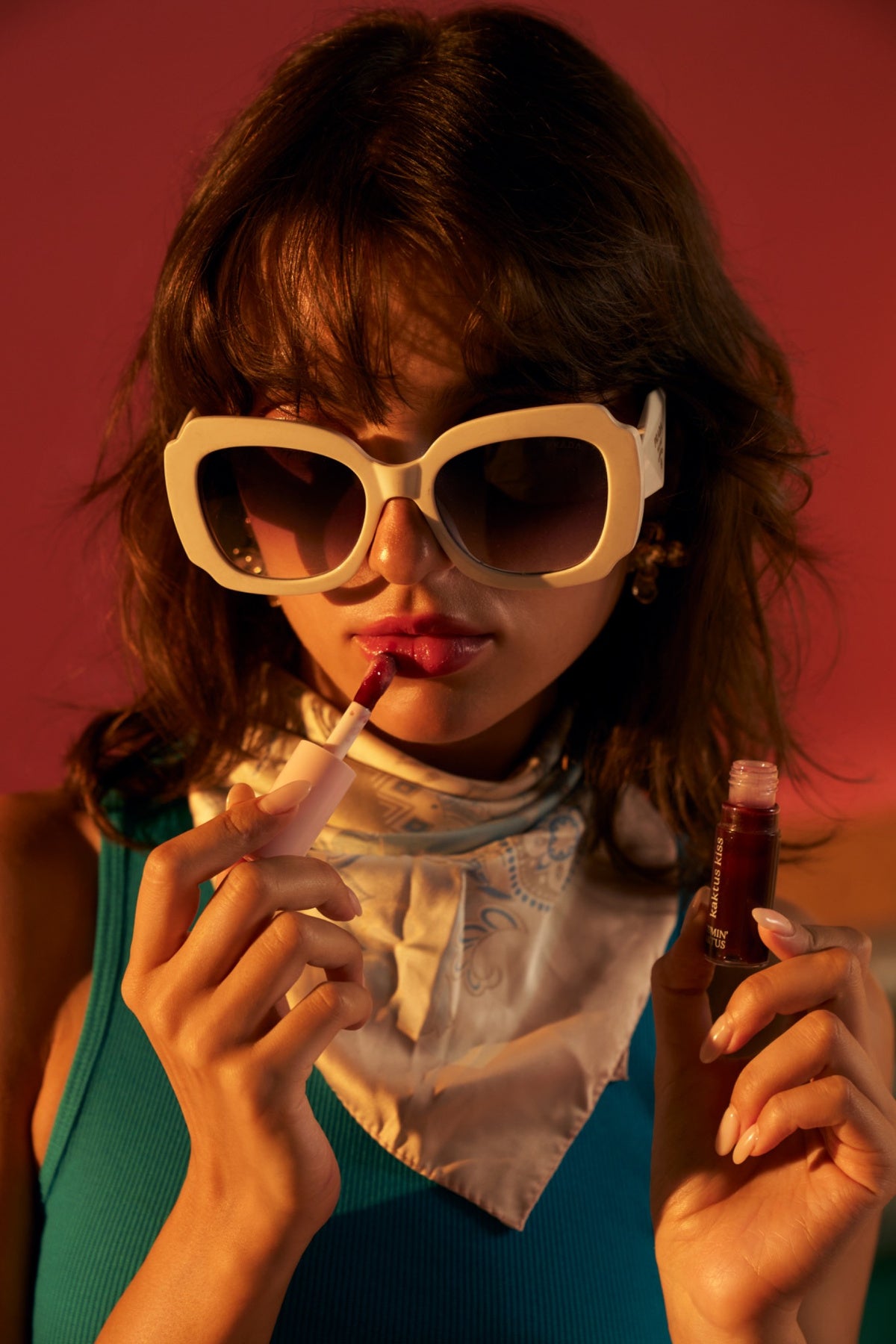 Model applying Glaze Guard Lip Oil SPF for shine, hydration and daily lip care.